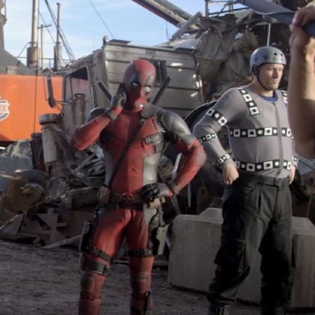 Deadpool and Andre Tricoteux are standng next to each other.